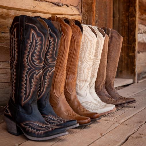 white ariat cowbgirl boots lined up in